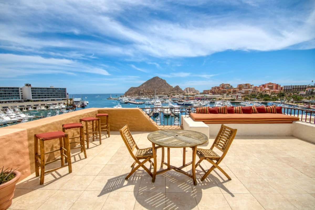 The penthouse's panoramic terrace looking out over the marina and the mountains beyond