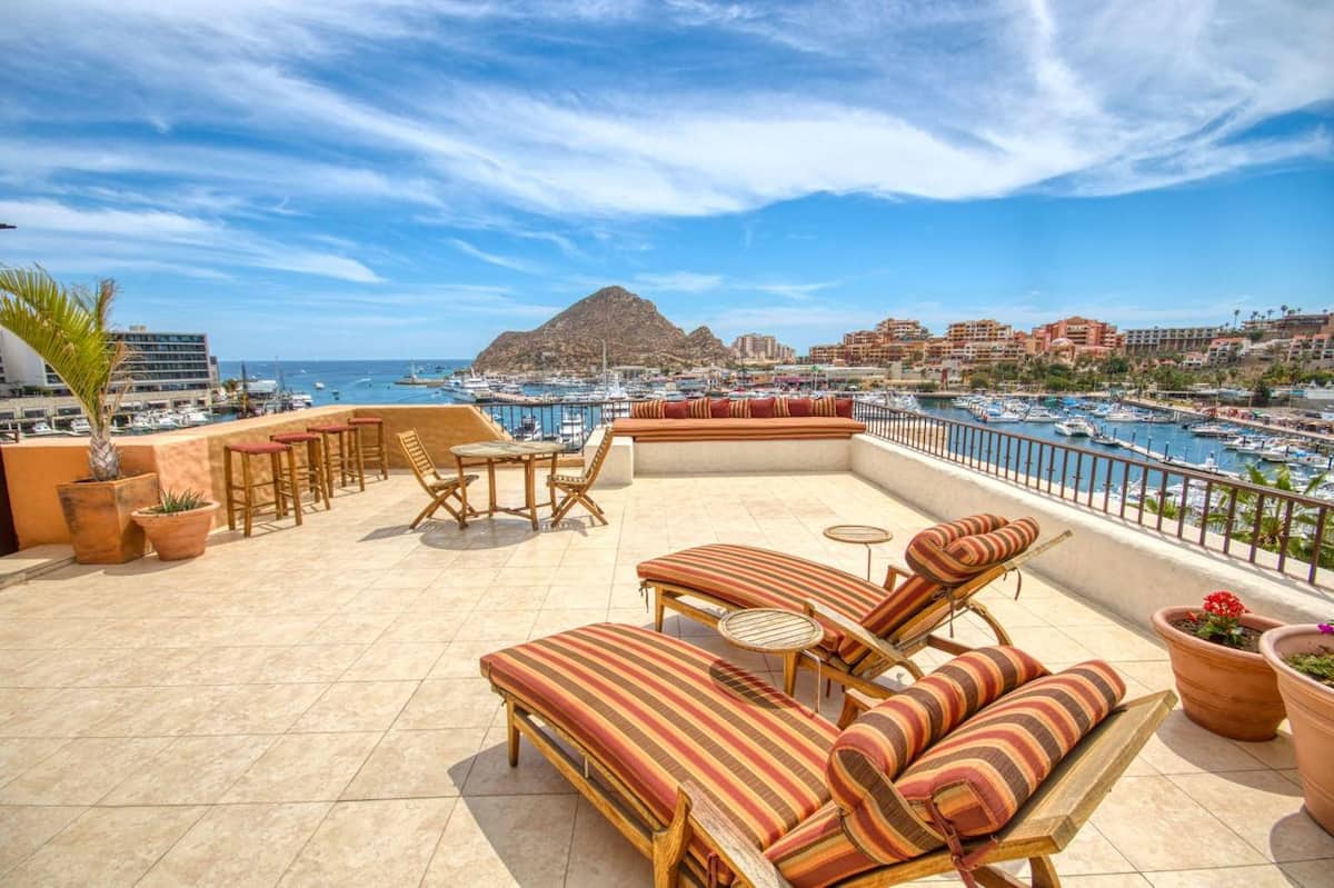 The penthouse terrace with sun loungers and a wide view over the marina